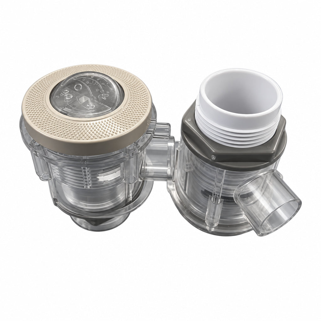 Two plastic plumbing components, likely a water filter or pressure regulator assembly, shown on a blue surface. One has a textured gray top cap with a clear dial, and the other has a white threaded opening.