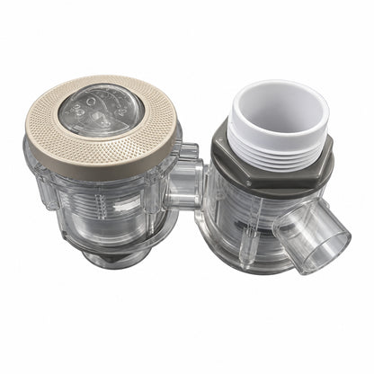 Two plastic plumbing components, likely a water filter or pressure regulator assembly, shown on a blue surface. One has a textured gray top cap with a clear dial, and the other has a white threaded opening.