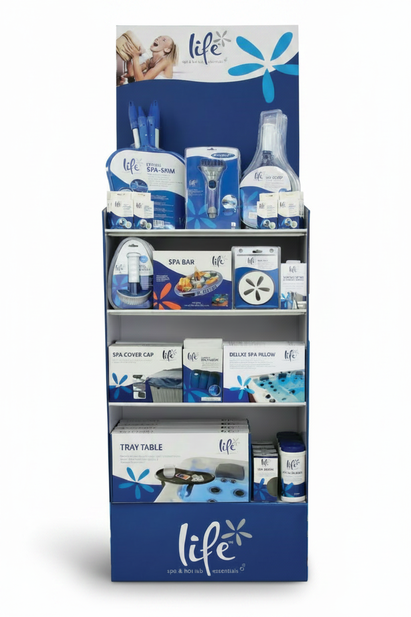 The image shows a tall, freestanding retail display unit branded ƒ??Lifeƒ?› Spa & Hot Tub Essentialsƒ?� in blue and white. The display consists of multiple shelves filled with neatly arranged packaged products.

Top Section: A branded header panel featuring a lifestyle image and blue floral design.
Upper Shelves: Hanging and boxed items including spa skimmers, brushes, scoop tools, and small accessories in uniform blue and white packaging.
Middle Shelves: Larger boxed items such as a spa bar tray table, spa